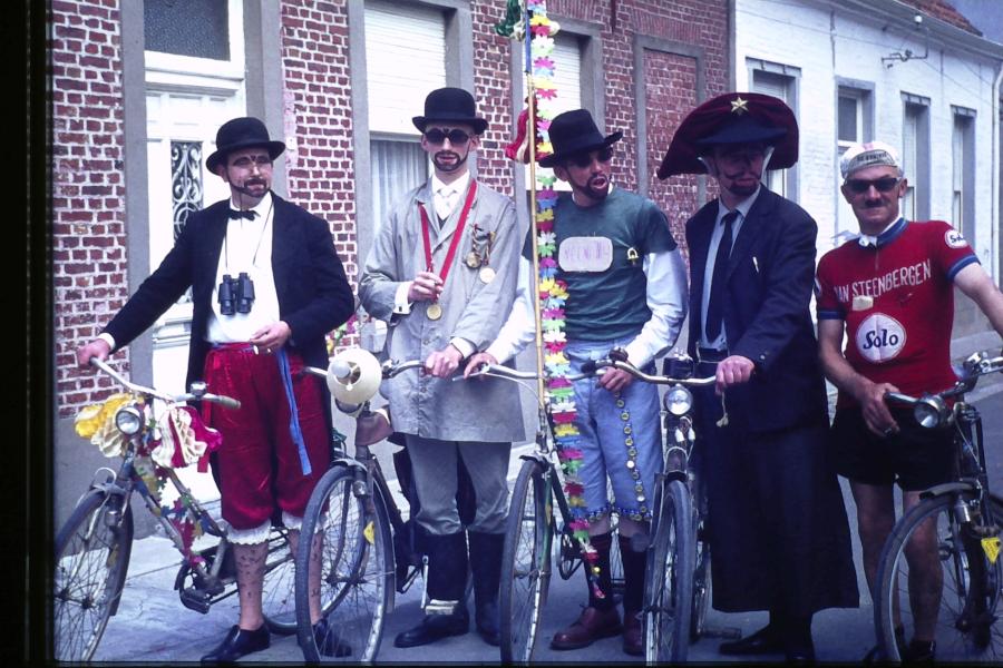 Niemand  ontsnapte aan  de  fijne  humor van de Tielrodenaren.  Op deze foto ziet men  een groep verklede Tielrodenaren die op de fiets de draak steken met bekende figuren. 